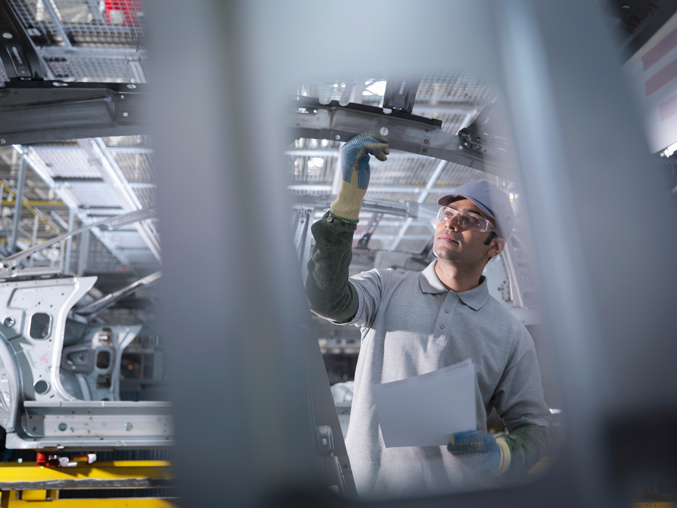 Car plant worker on production line